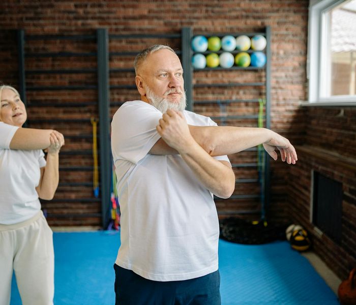 Woman stretching gracefully outdoors, showing flexibility and strength.